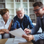 Senior couple talking to one of the top 5 best estate planning attorneys in the United States, getting the info they need.