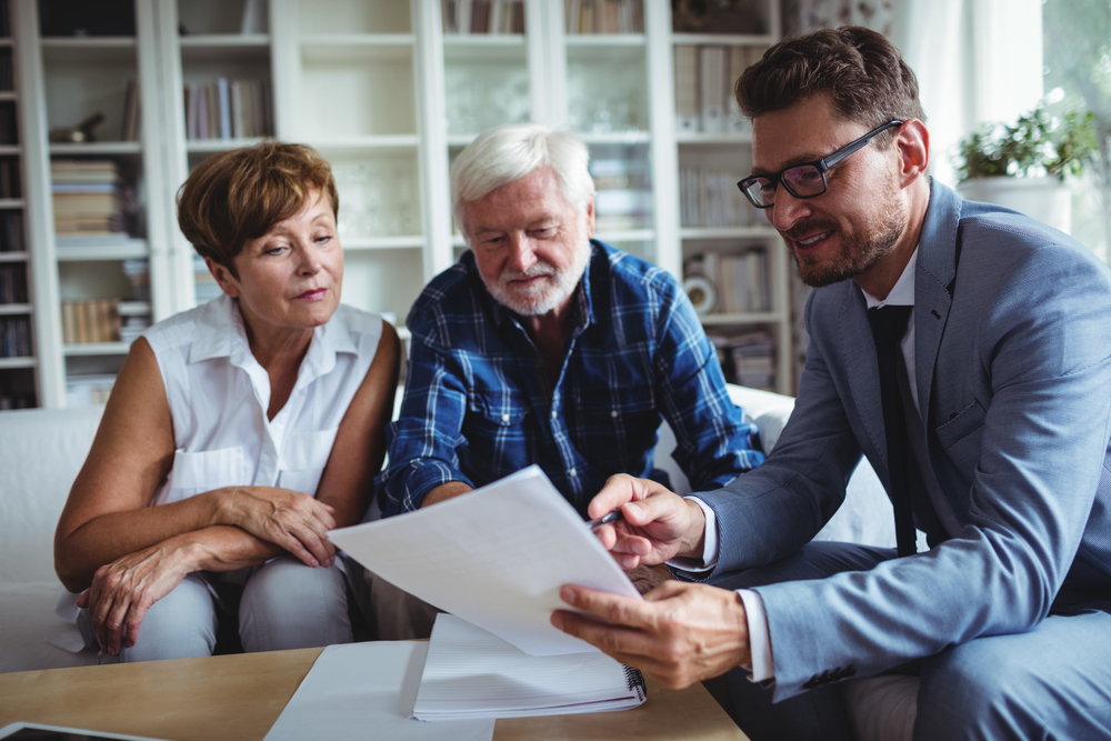 Senior couple talking to one of the top 5 best estate planning attorneys in the United States, getting the info they need.